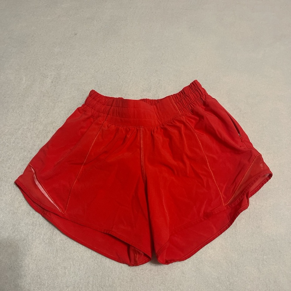 Red Lululemon shorts, one pocket on side, another small pocket inside.